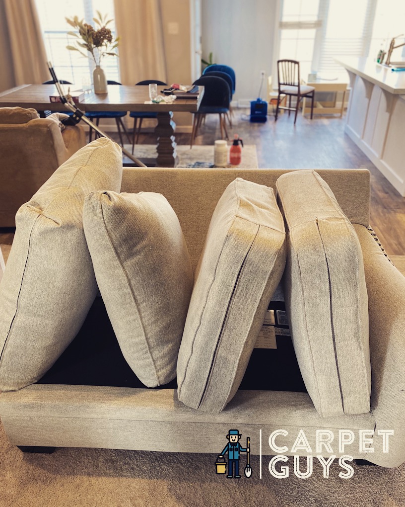 Tan fabric sofa with lifted cushions — residential upholstery cleaning