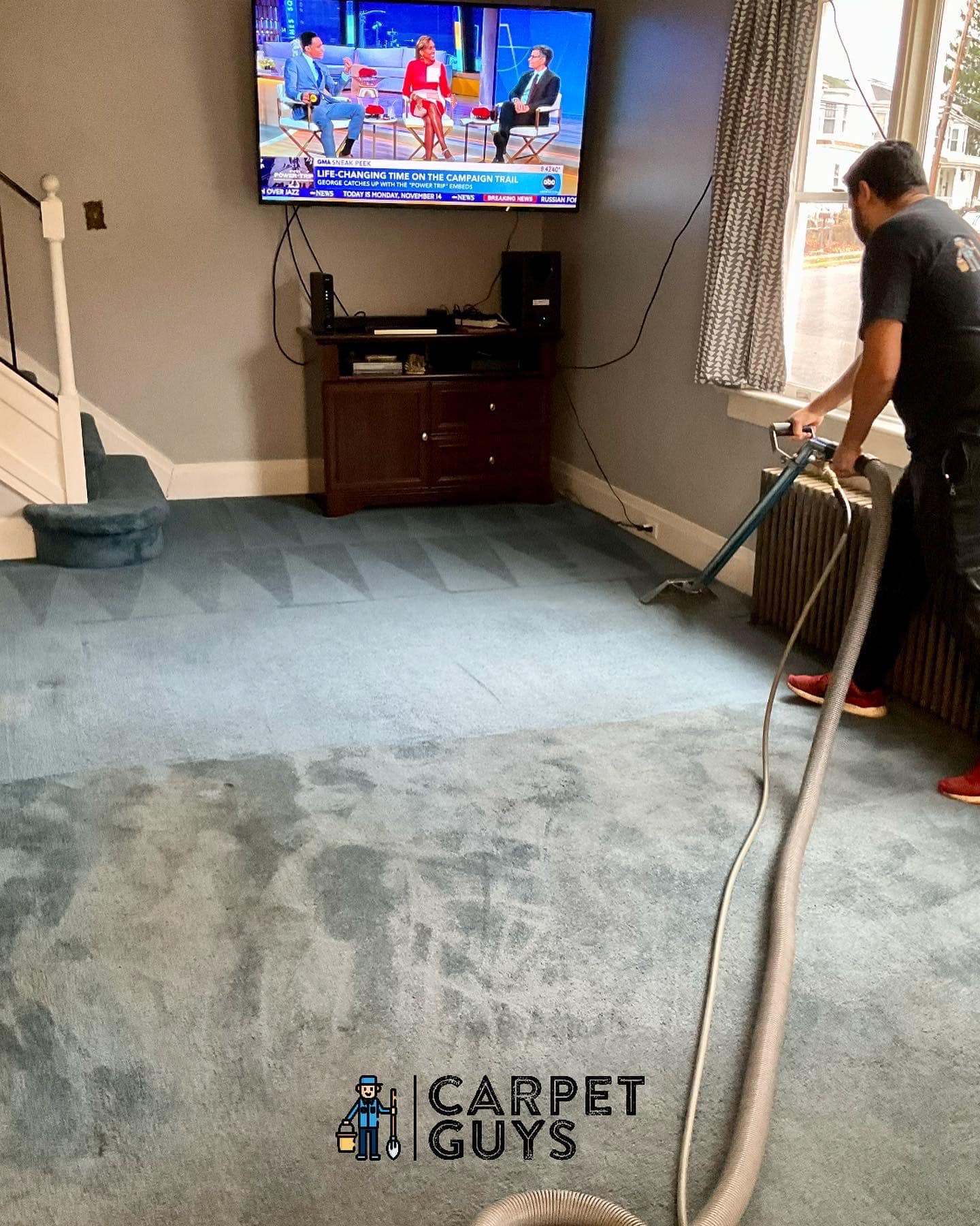 Technician using extraction wand on blue carpet in a real Central PA home
